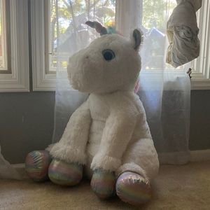 Stuffed unicorn with pastel hooves and horn